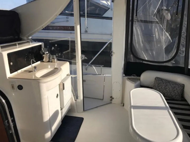 Slide: The Image of Interior of 2004 Meridian 459 Motoryacht with sink, seating, and window views. - 22