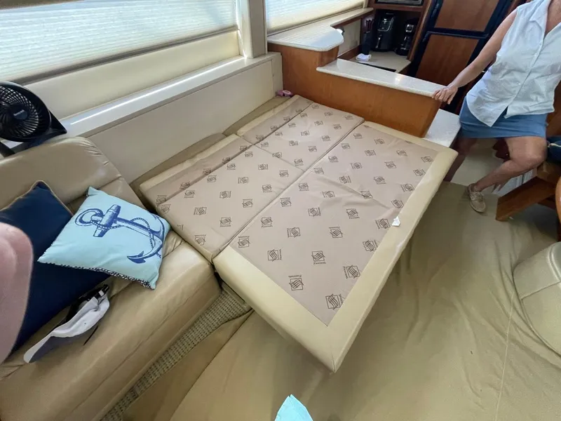 Slide: The Image of 2004 Meridian 459 Motoryacht interior with beige seating and nautical-themed decor. - 28