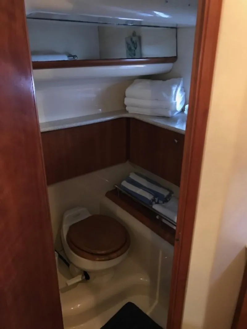 Slide: The Image of 2004 Meridian 459 Motoryacht bathroom with wooden cabinetry and shelving. - 39