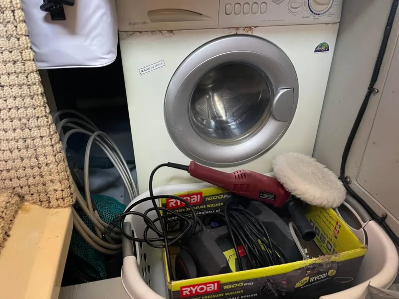 Slide: The Image of Laundry area on 2004 Meridian 459 Motoryacht with washing machine and cleaning tools. - 41