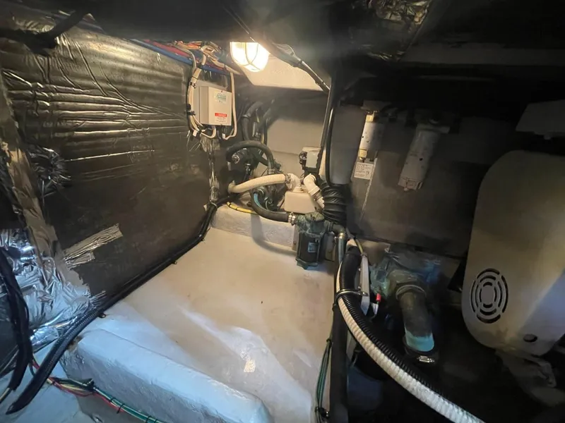 Slide: The Image of Engine room of 2004 Meridian 459 Motoryacht, showcasing mechanical components and wiring. - 46