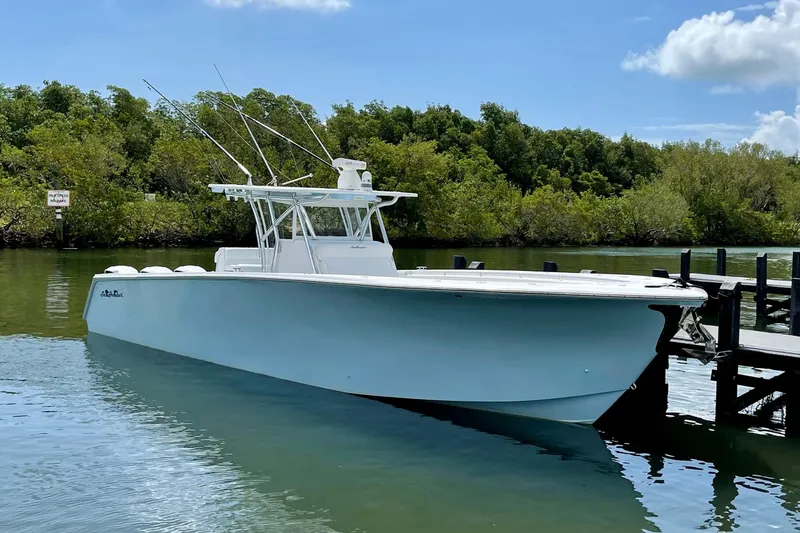 Slide: The Image of 2016 SeaHunter 41 Tournament boat docked in serene waters, surrounded by lush greenery. - 1