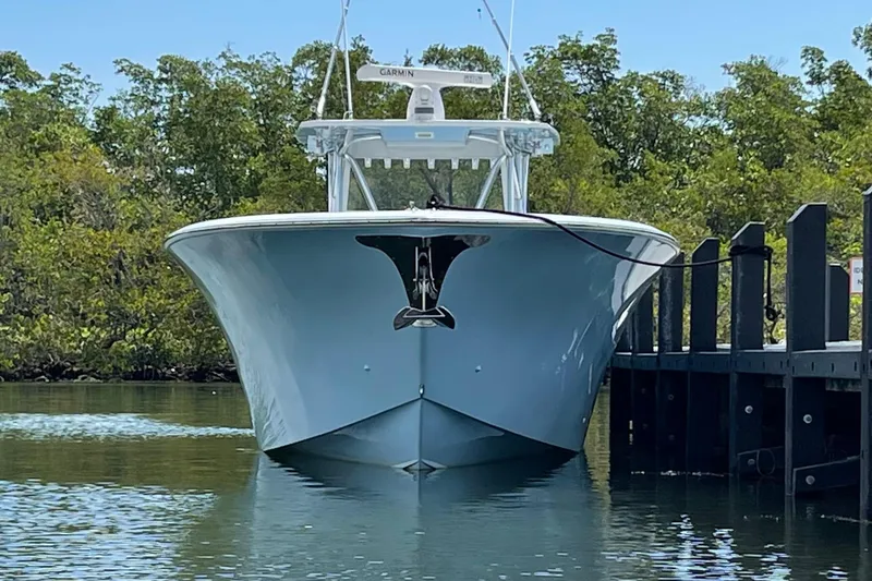 Slide: The Image of 2016 SeaHunter 41 Tournament boat docked, front view, surrounded by trees. - 2