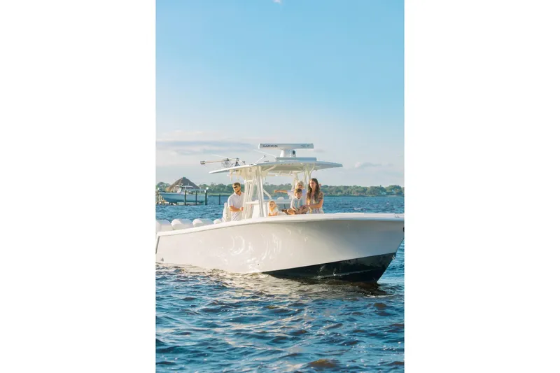 Slide: The Image of 2018 SeaVee 390Z boat cruising with passengers on a sunny day. - 2