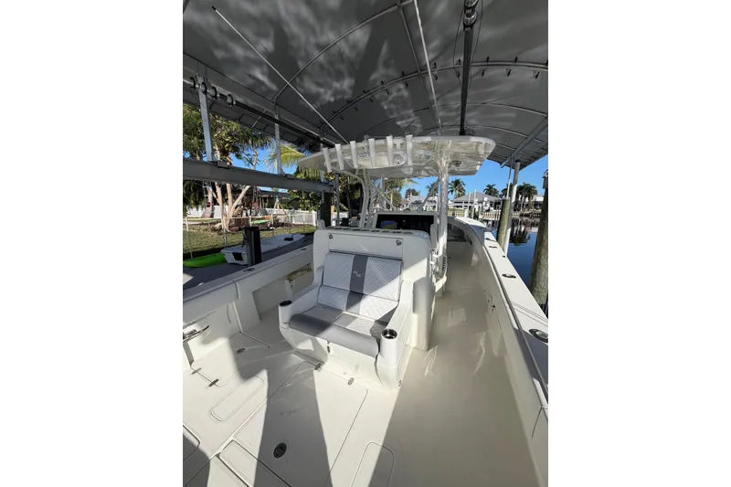 Slide: The Image of 2018 SeaVee 390Z boat interior with seating, rod holders, and canopy. - 7