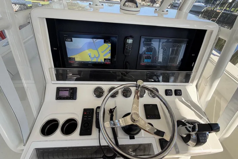 Slide: The Image of 2018 SeaVee 390Z helm with navigation screens and controls. - 9