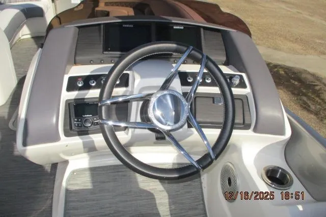 Slide: The Image of 2022 Bennington RX Sport Line boat dashboard with steering wheel and controls. - 3