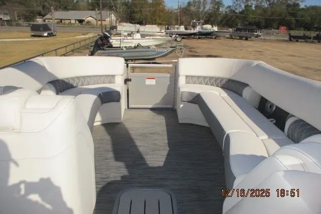 Slide: The Image of 2022 Bennington RX Sport Line boat with spacious seating, docked in a marina. - 4