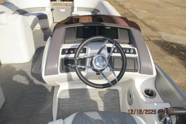 Slide: The Image of 2022 Bennington RX Sport Line boat dashboard with steering wheel and controls. - 5