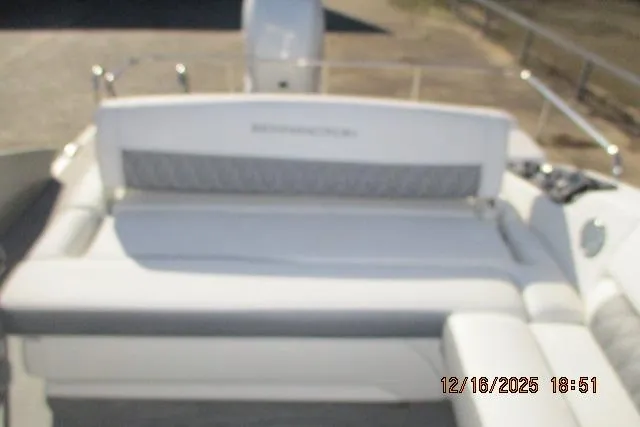 Slide: The Image of 2022 Bennington RX Sport Line boat with cushioned seating, blurred background. - 7