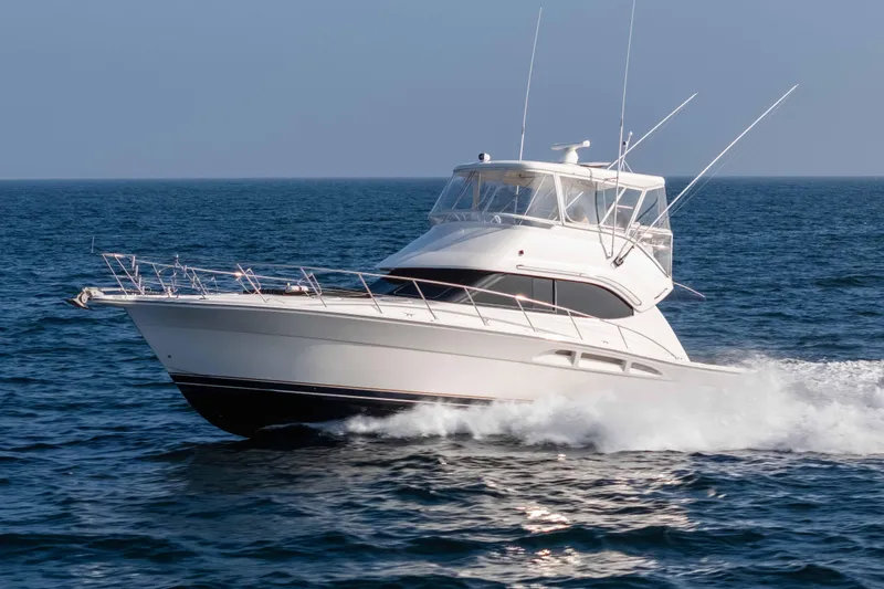 Slide: The Image of 2005 Riviera 47 Convertible yacht cruising on open sea. - 11