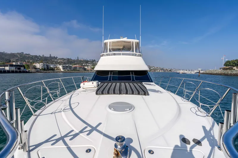 Slide: The Image of 2005 Riviera 47 Convertible yacht on calm waters, showcasing sleek design and luxury features. - 13