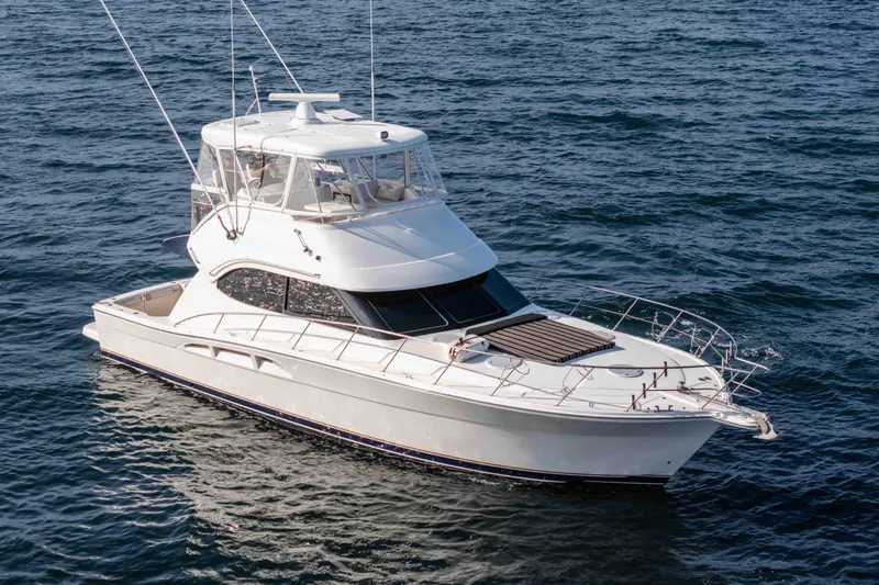 Slide: The Image of 2005 Riviera 47 Convertible yacht cruising on open water. - 14
