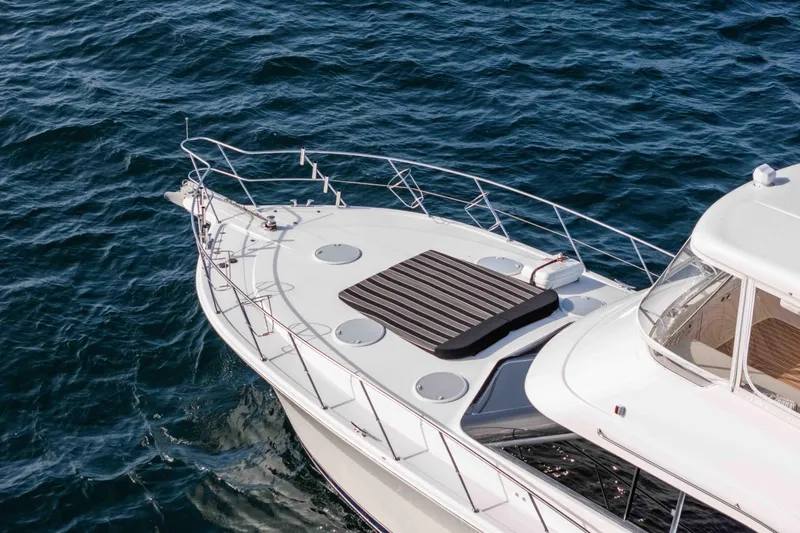 Slide: The Image of 2005 Riviera 47 Convertible yacht on open water, showcasing sleek design and luxury features. - 15