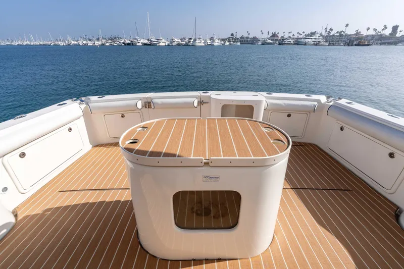 Slide: The Image of 2005 Riviera 47 Convertible yacht deck with ocean view and marina backdrop. - 18