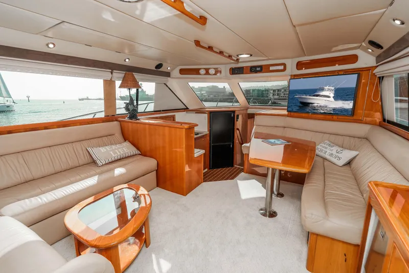 Slide: The Image of Luxurious interior of 2005 Riviera 47 Convertible yacht with plush seating and ocean view. - 24