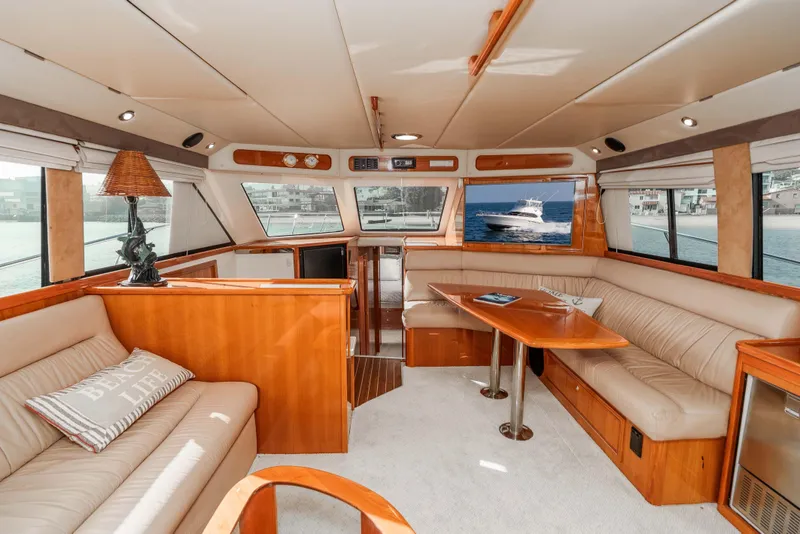 Slide: The Image of Luxurious interior of 2005 Riviera 47 Convertible yacht with elegant seating and wooden finishes. - 25