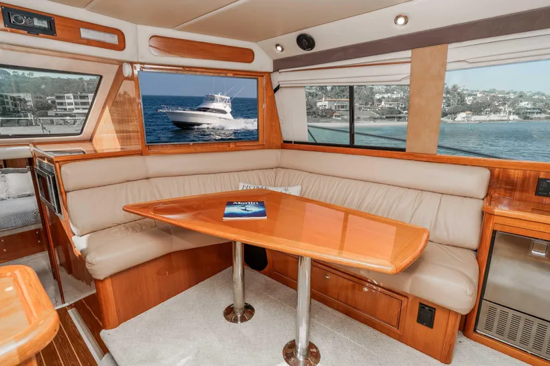 Slide: The Image of Interior of 2005 Riviera 47 Convertible yacht with elegant seating and ocean view. - 26