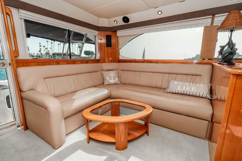 Slide: The Image of Luxurious interior of 2005 Riviera 47 Convertible yacht with beige leather seating and nautical decor. - 27