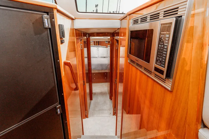 Slide: The Image of Interior of 2005 Riviera 47 Convertible yacht with wood finish and modern appliances. - 29