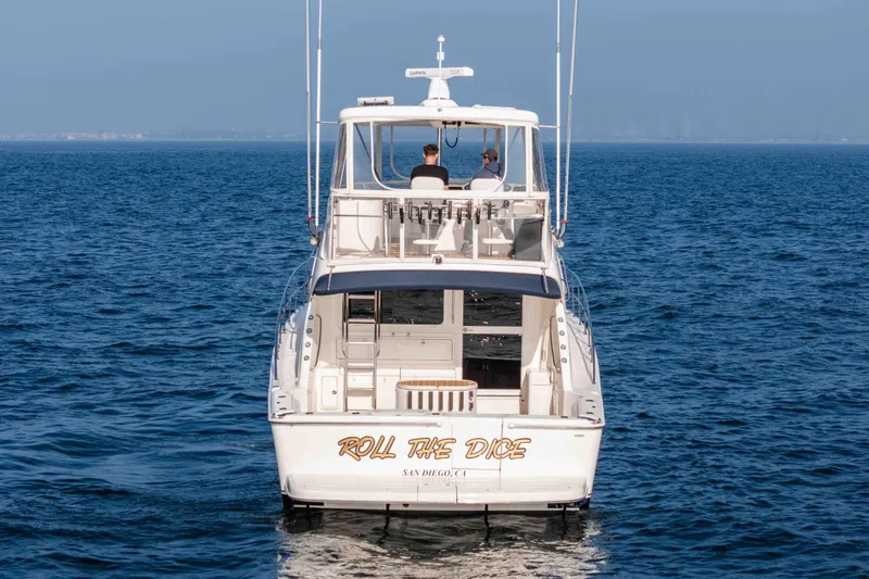 Slide: The Image of 2005 Riviera 47 Convertible yacht "Roll the Dice" cruising on open sea. - 3