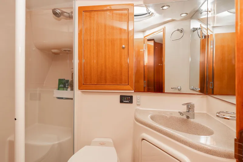 Slide: The Image of Luxurious bathroom interior of 2005 Riviera 47 Convertible yacht with wooden cabinetry. - 33