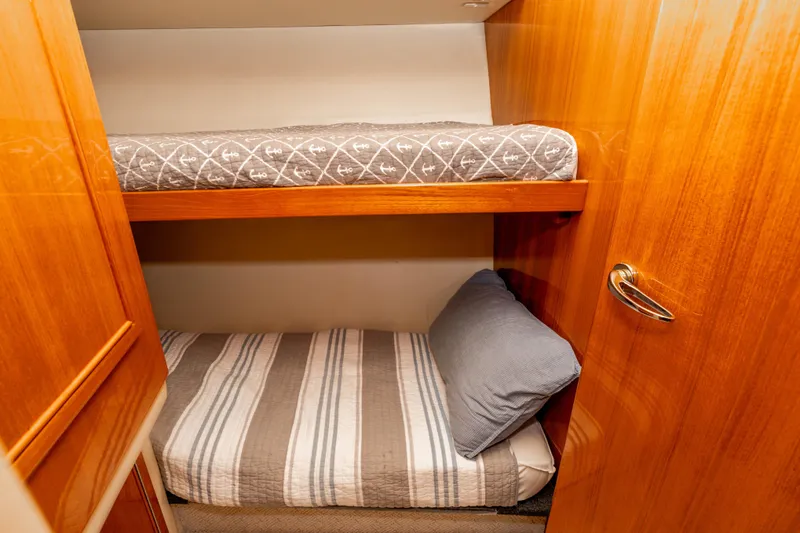 Slide: The Image of Bunk beds in 2005 Riviera 47 Convertible yacht cabin with wooden finish. - 34