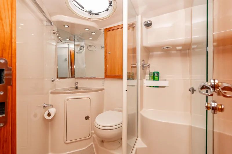 Slide: The Image of Luxurious bathroom in 2005 Riviera 47 Convertible yacht with modern fixtures and glass shower. - 36
