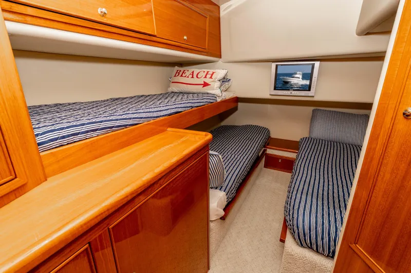 Slide: The Image of 2005 Riviera 47 Convertible cabin with twin beds and nautical decor. - 37