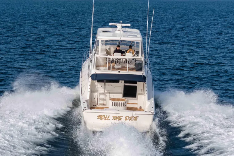 Slide: The Image of 2005 Riviera 47 Convertible yacht cruising on open water. - 4
