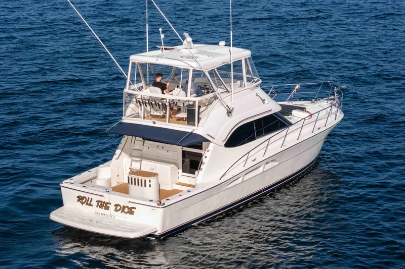 Slide: The Image of 2005 Riviera 47 Convertible yacht cruising on open water. - 5