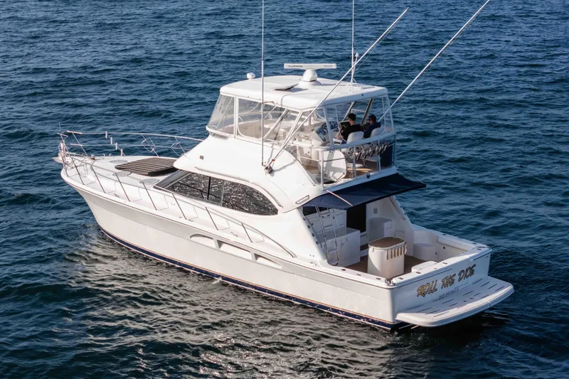 Slide: The Image of 2005 Riviera 47 Convertible yacht cruising on open water. - 7
