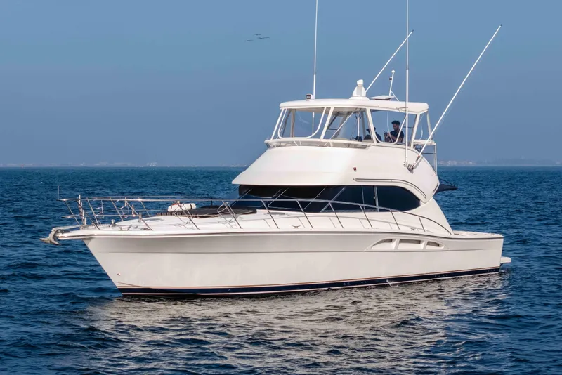 Slide: The Image of 2005 Riviera 47 Convertible yacht cruising on open water. - 9