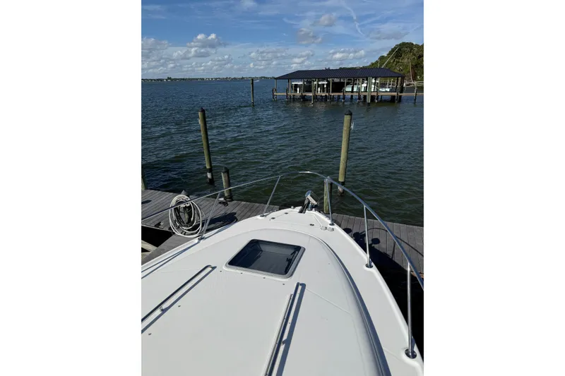 Slide: The Image of 2009 Chaparral 290 Signature boat docked by a serene waterfront. - 20