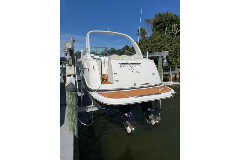 Slide: The Image of 2009 Chaparral 290 Signature boat docked, rear view with dual propellers. - 3