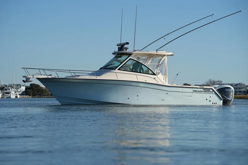 Slide: The Image of 2024 Grady-White Express 330 boat on calm water, side view. - 2