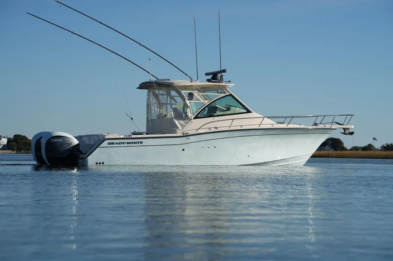 Slide: The Image of 2024 Grady-White Express 330 boat on calm water, side view. - 20
