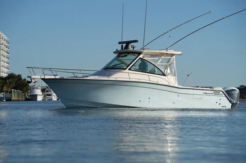 Slide: The Image of 2024 Grady-White Express 330 boat on calm water, showcasing sleek design and modern features. - 3