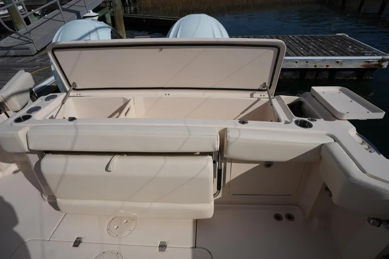 Slide: The Image of 2024 Grady-White Express 330 boat interior with open storage compartment. - 34