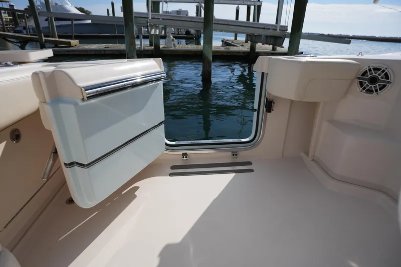 Slide: The Image of 2024 Grady-White Express 330 boat interior with open transom door, dockside view. - 38