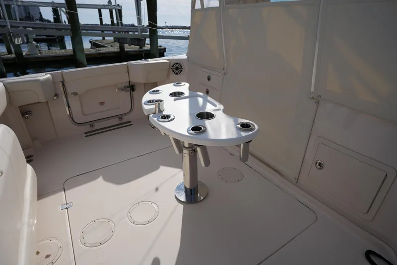 Slide: The Image of 2024 Grady-White Express 330 boat interior with table and cup holders. - 39