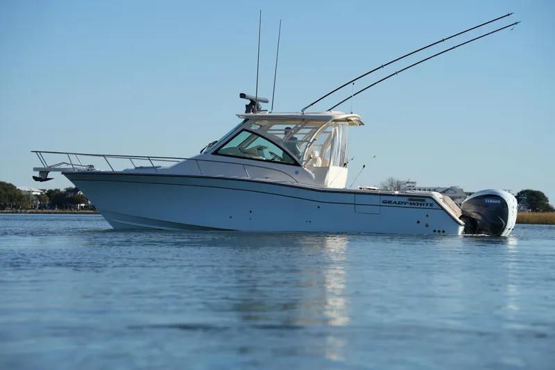 Slide: The Image of 2024 Grady-White Express 330 boat on calm water, side view. - 4