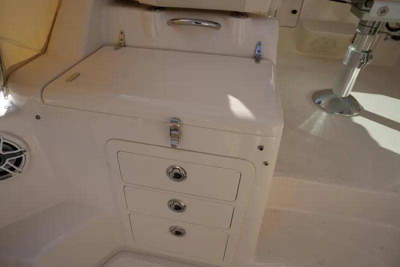 Slide: The Image of 2024 Grady-White Express 330 boat interior with storage drawers and seating area. - 41