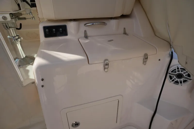 Slide: The Image of 2024 Grady-White Express 330 interior with storage compartment and control panel. - 43