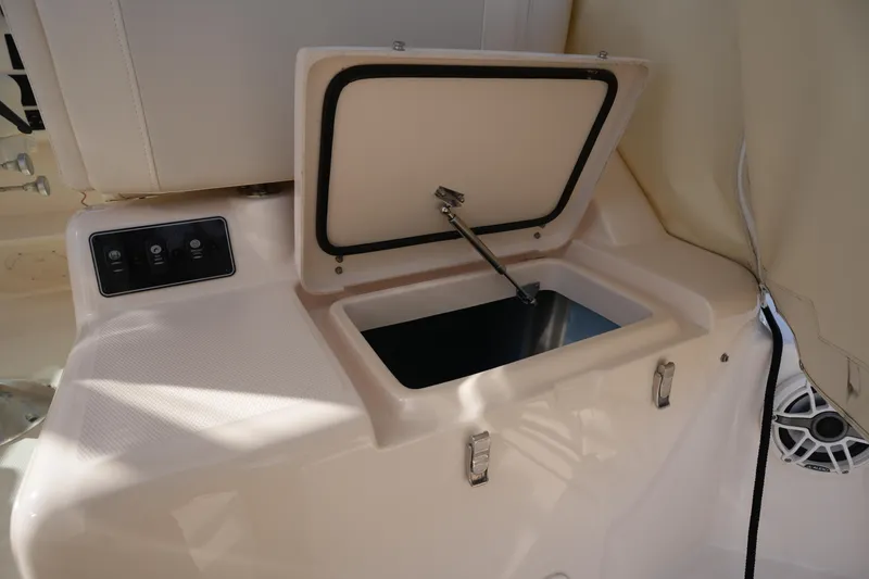 Slide: The Image of 2024 Grady-White Express 330 boat storage compartment with open lid and control panel. - 44