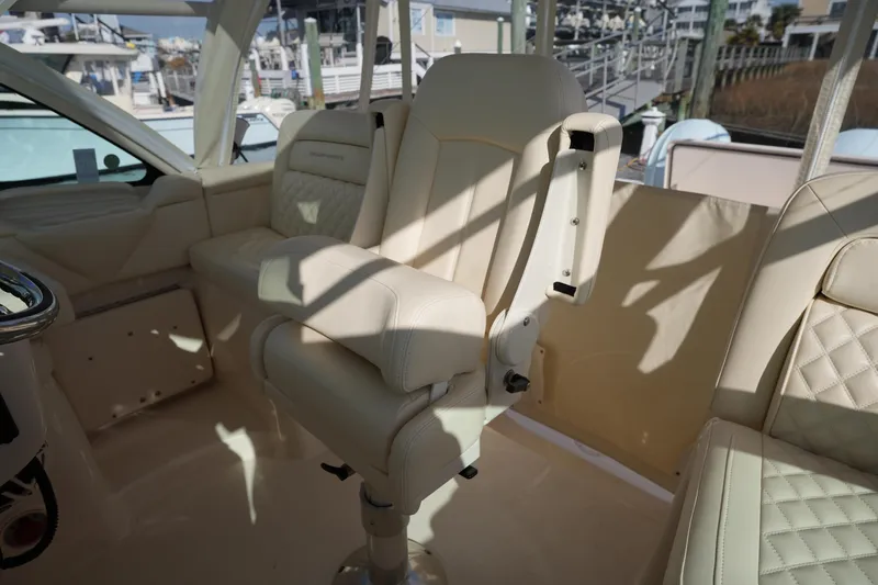 Slide: The Image of 2024 Grady-White Express 330 interior with luxurious beige seating and helm station. - 46