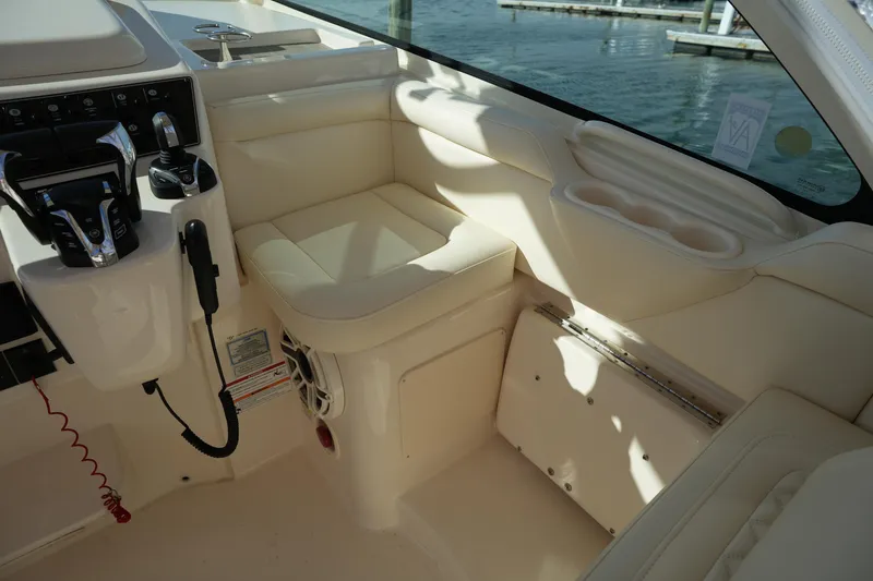 Slide: The Image of 2024 Grady-White Express 330 boat interior with helm controls and seating. - 48
