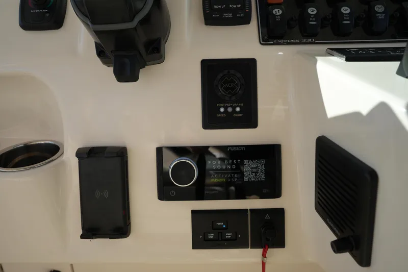 Slide: The Image of Control panel of 2024 Grady-White Express 330 boat with various electronic devices. - 53