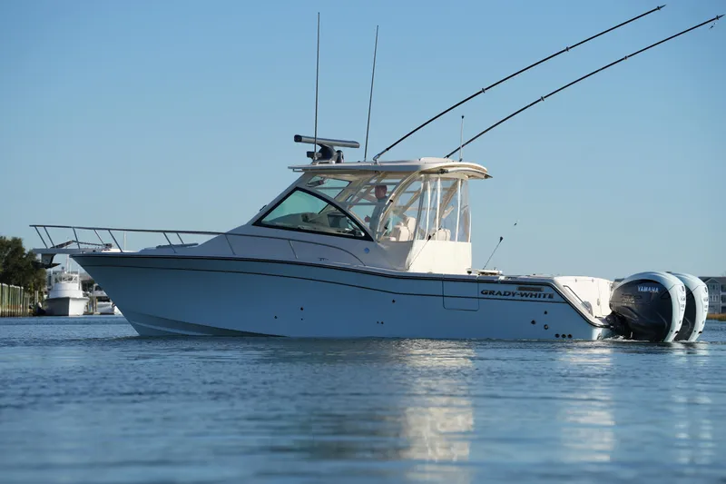 Slide: The Image of 2024 Grady-White Express 330 boat on calm water, side view. - 6