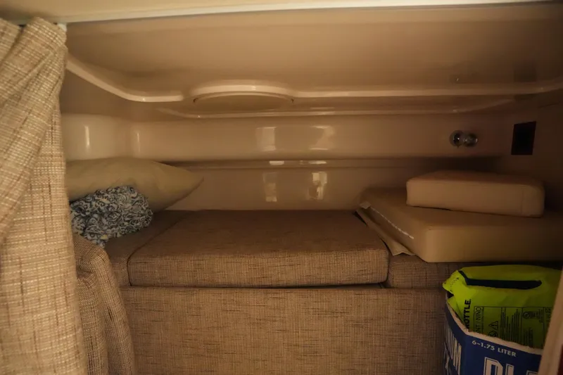 Slide: The Image of 2024 Grady-White Express 330 cabin interior with bedding and storage. - 70